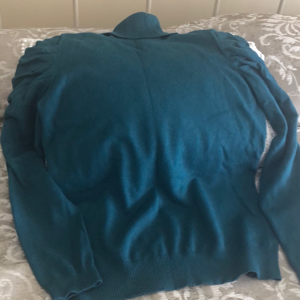 Emerald green sweater with pleated shoulders.